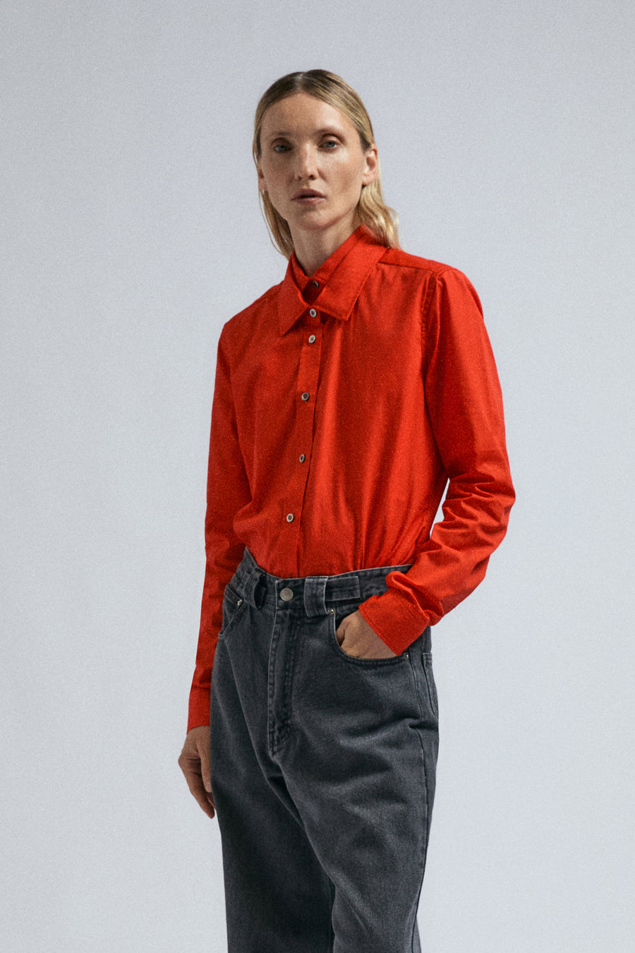 Woman wears FW24 red Joker Shirt, paired with black Insignia Jeans.