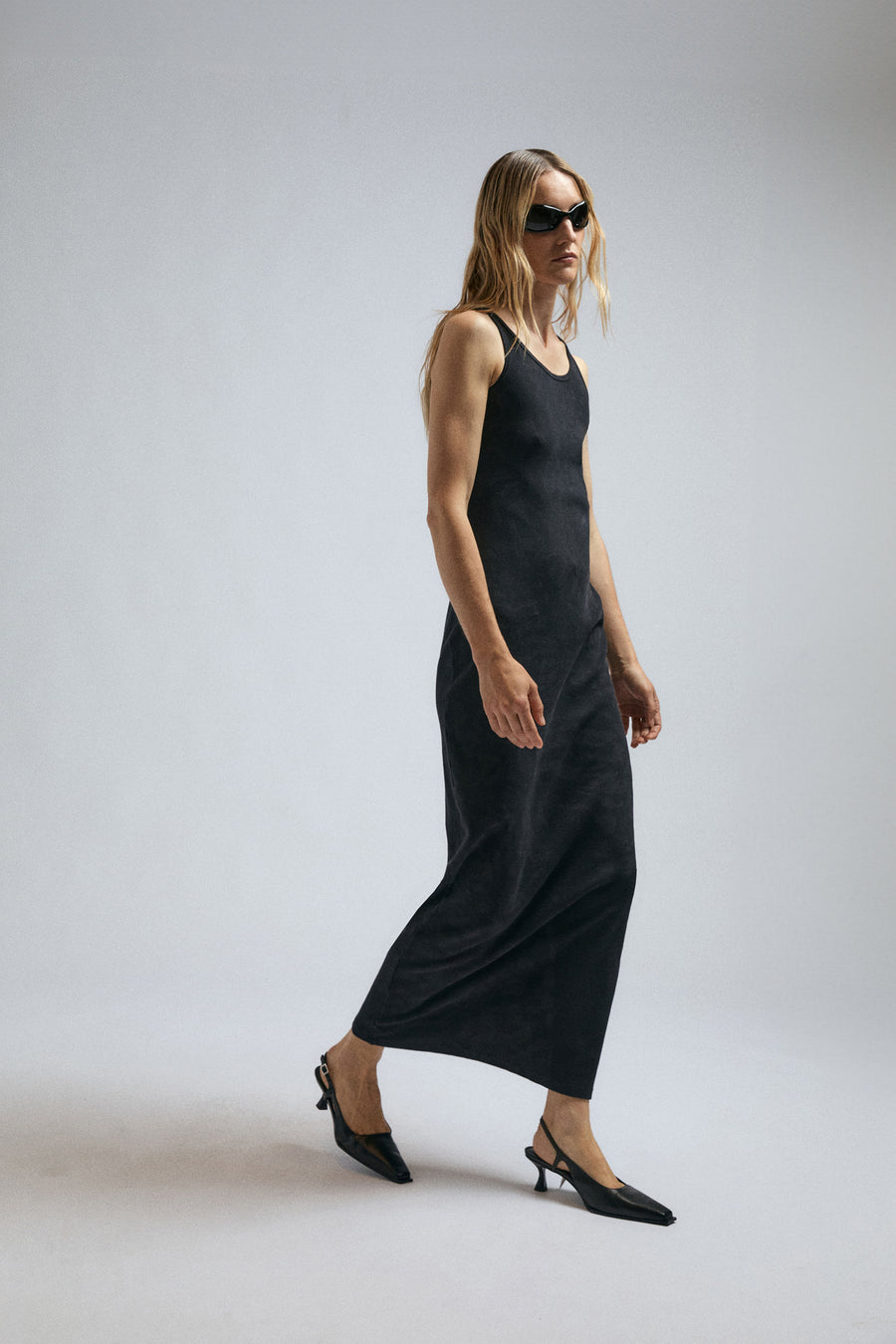 Woman wearing black jersey dress by JordanLuca with XP1 sunglasses.