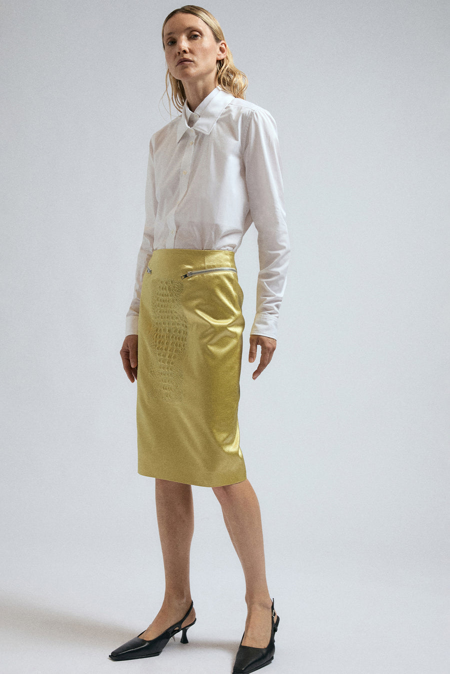 Woman wears double collar White Joker Shirt, paired with Canary Yellow Bumpster Skirt